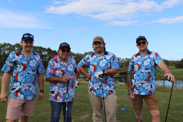 Michael, Barry, Luke, and Adam from Devcon - wearing blue shirts and playing golf for charity 
